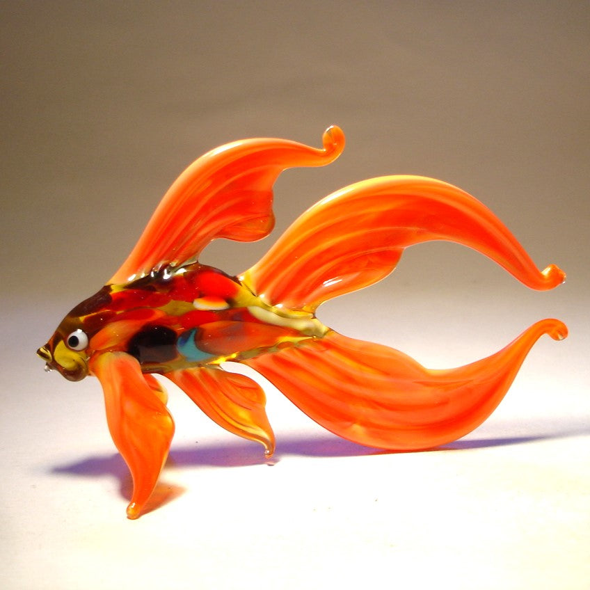 Another view of the orange Betta fish glass figurine, showing the elegant curvature of the fish’s body and the wide double tail.