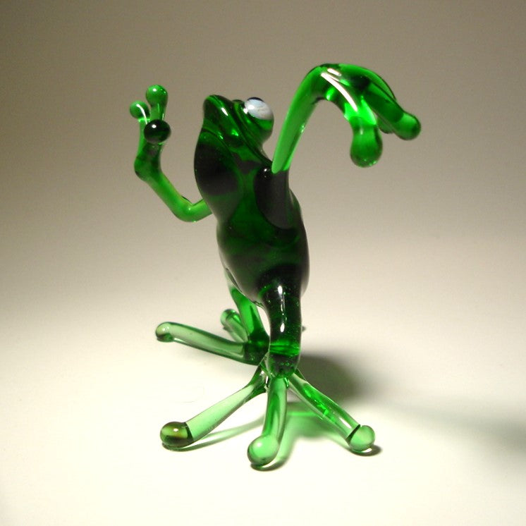 Side view of the glass dancing frog figurine, highlighting the frog's playful posture and vibrant green color.