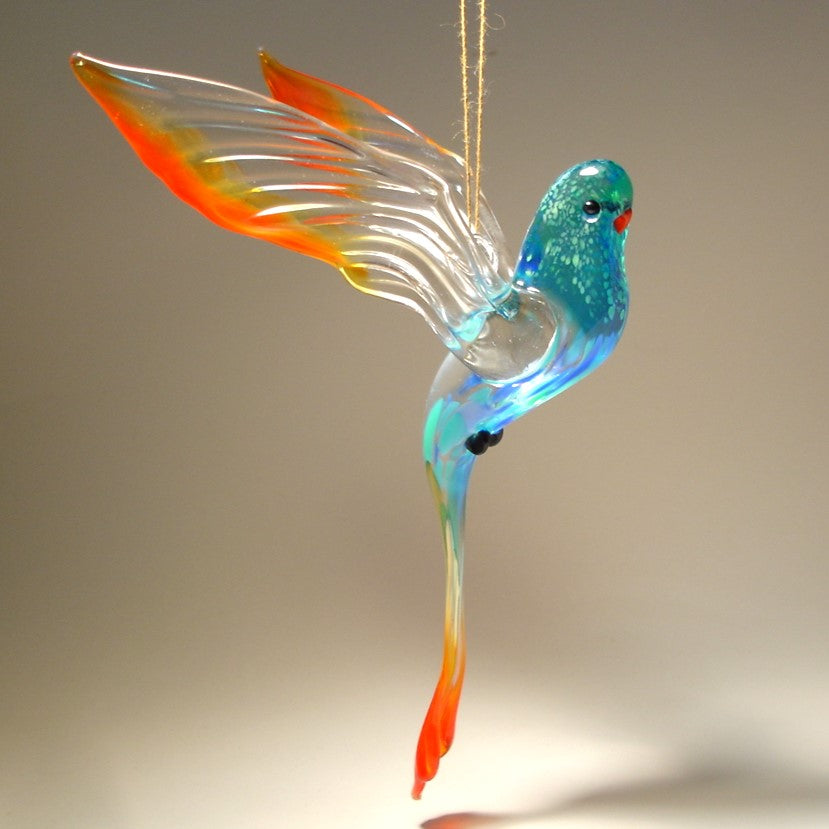 A colorful glass Hanging Blue & Red Parrot Parakeet ornament, gracefully suspended, showcasing its vibrant blue and red feathers.