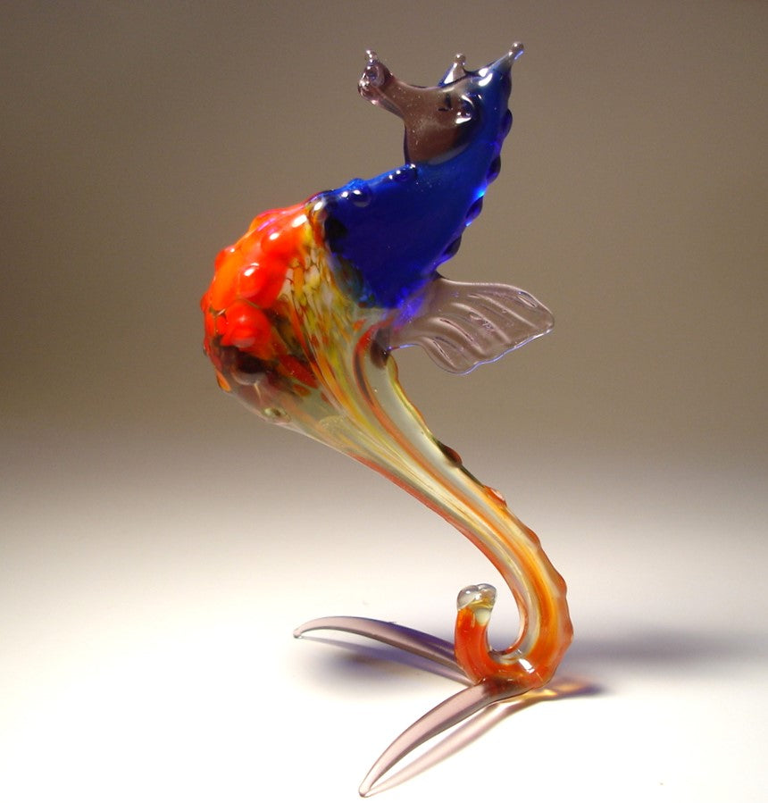 The seahorse features intricate details, including a coiled tail and a textured body, with its head slightly tilted, showcasing its elegant and lifelike design.