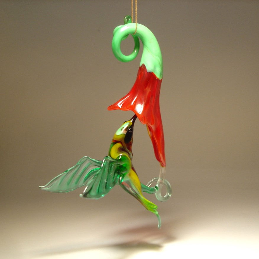 The other side of the hanging hummingbird and a red trumpet flower