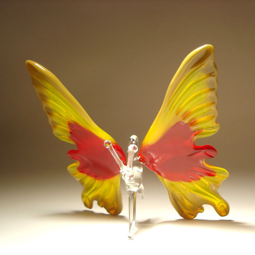 A decorative butterfly sculpture with translucent yellow wings featuring red and orange inner sections.