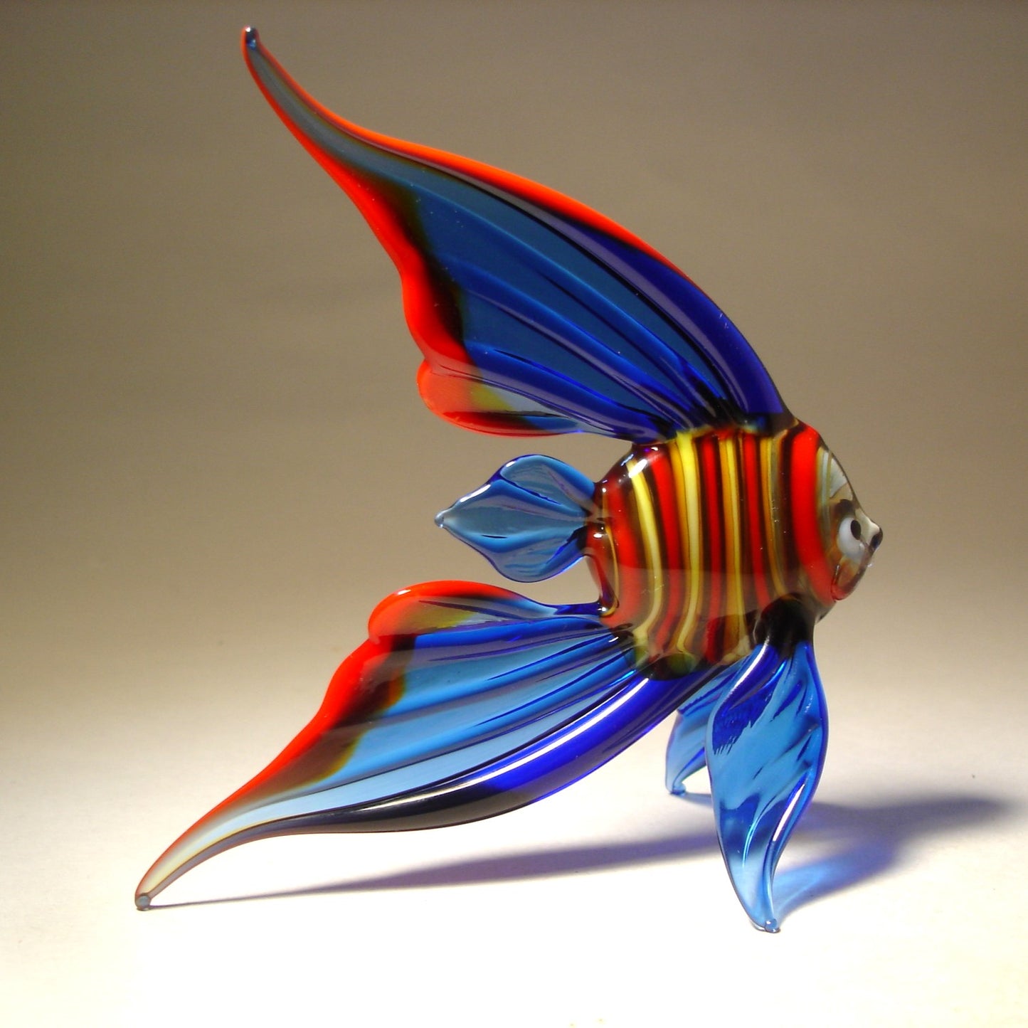 Glass blue fish with tail trimmed in red