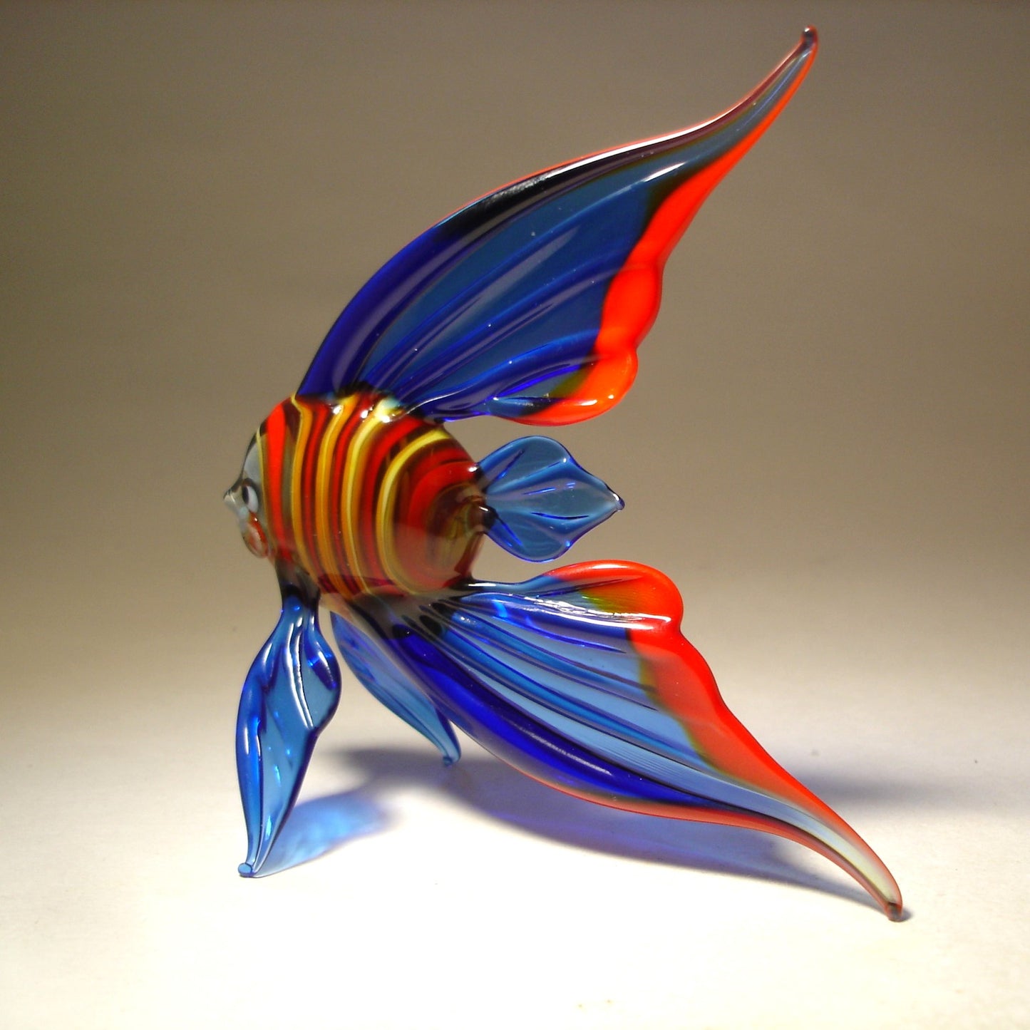 Side view of the blue and red glass fish