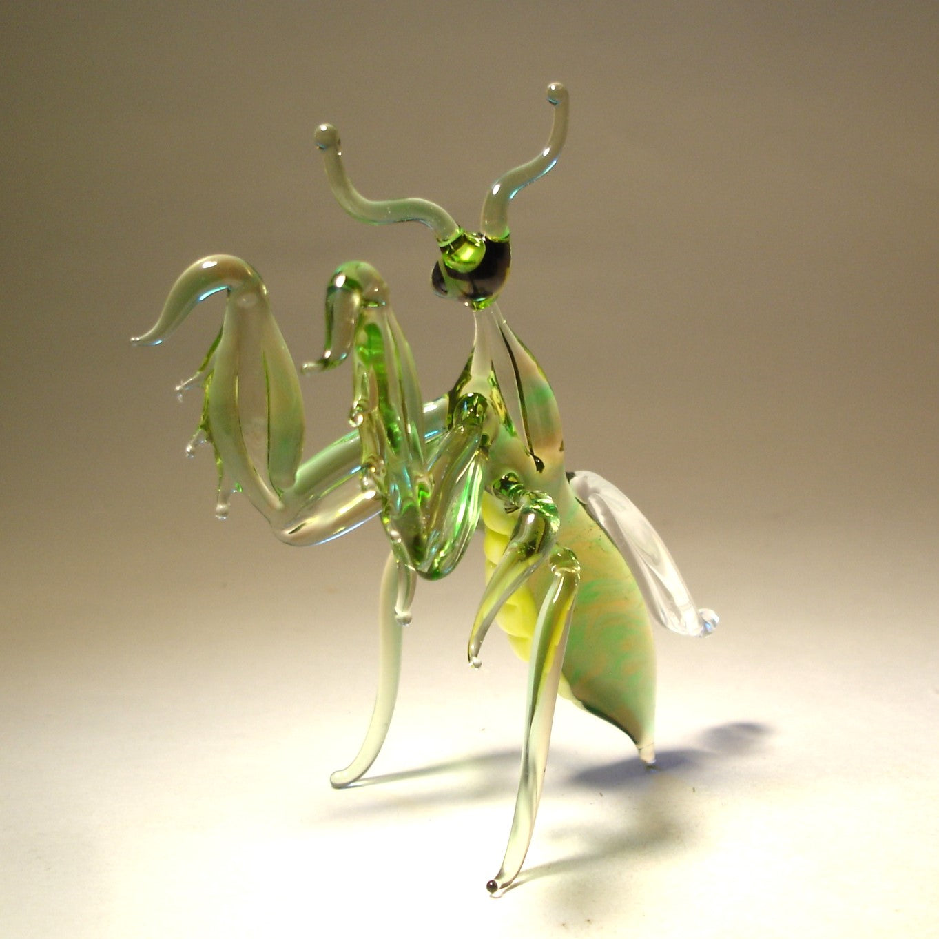 The other view of the glass mantis figurine showing intricate front legs.
