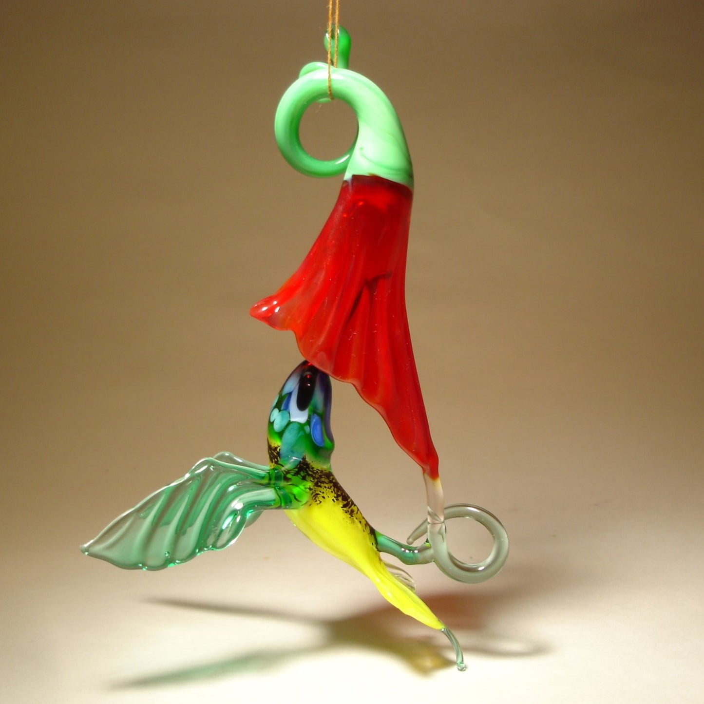 The other side of the hanging hummingbird and a red trumpet flower