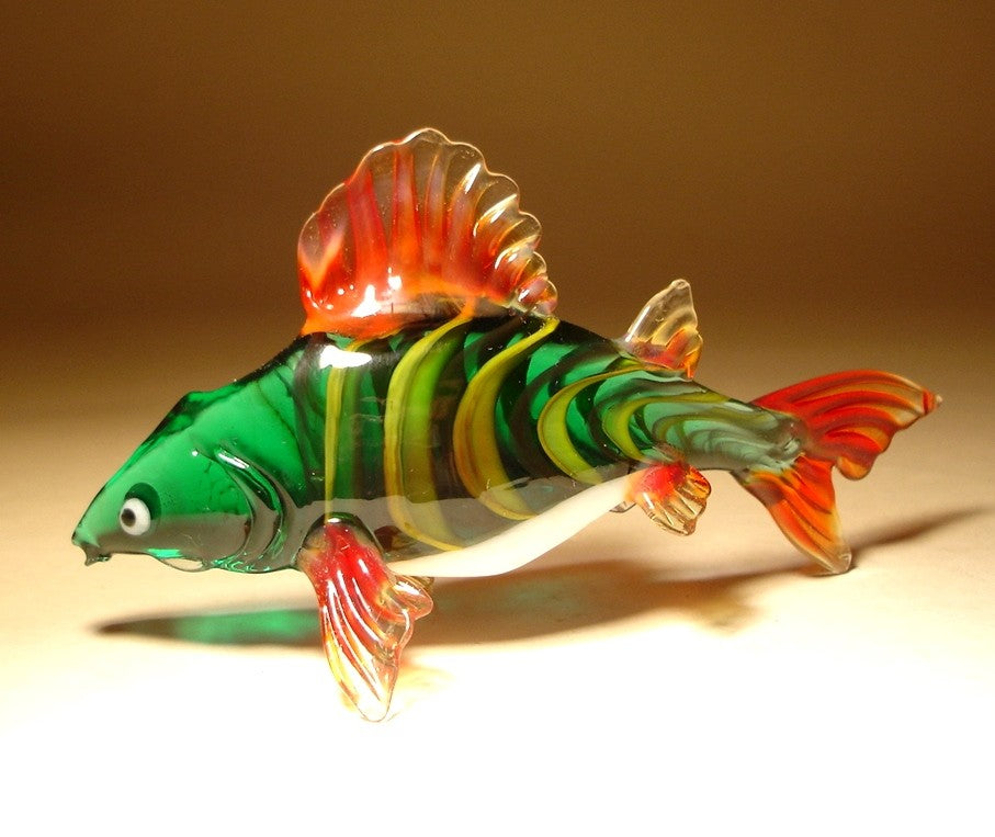 A side view of the glass carp figurine, showcasing its large, flowing fins and slightly opened mouth.