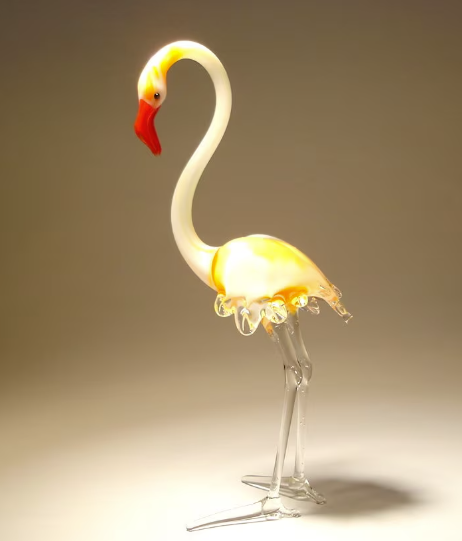 A beautifully crafted glass flamingo figurine standing firmly on both legs.