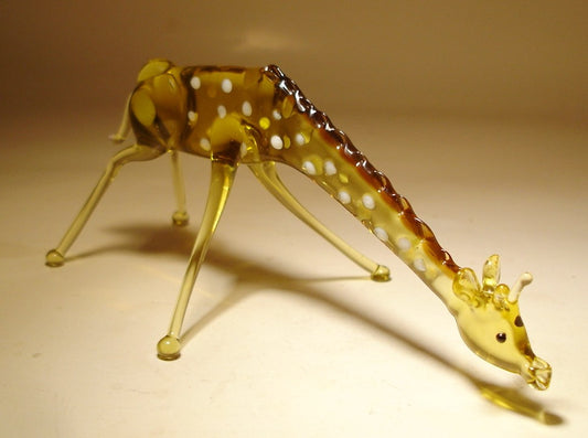 Front view of a glass giraffe figurine bending down to drink water, showcasing its long neck and intricate body details