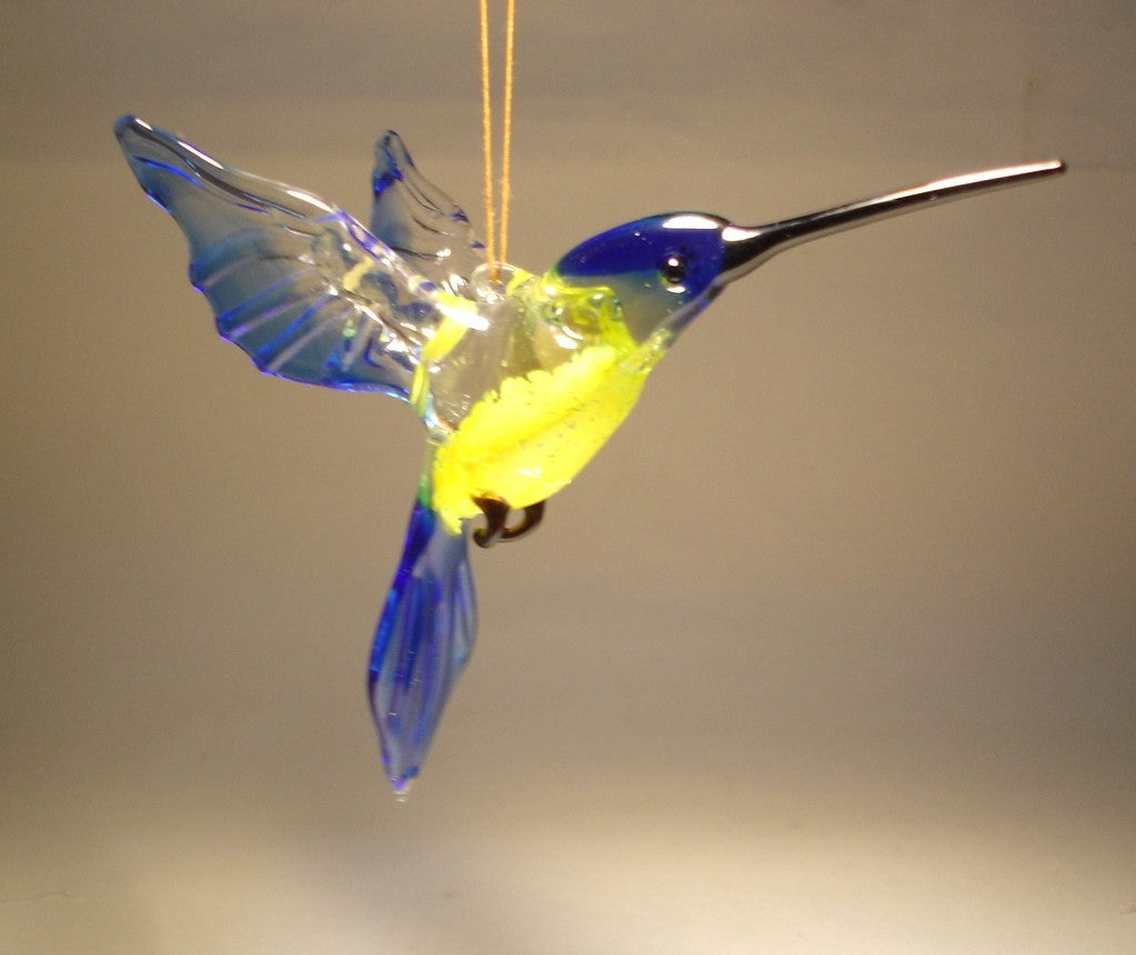 blue and yellow glass hanging hummingbird ornament, suspended from the string