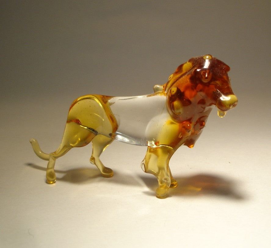 A side view of the glass lion figurine, highlighting its strong posture and a beautiful mane.
