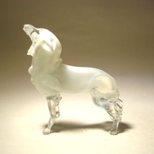 Side view of a stunning glass polar wolf figurine in a howling pose.