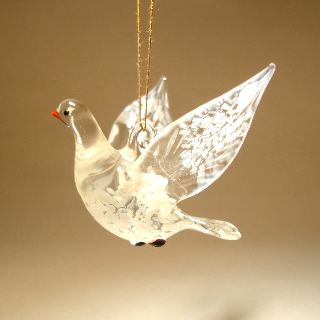 Another view of the white dove glass ornament with its head turned to the right.