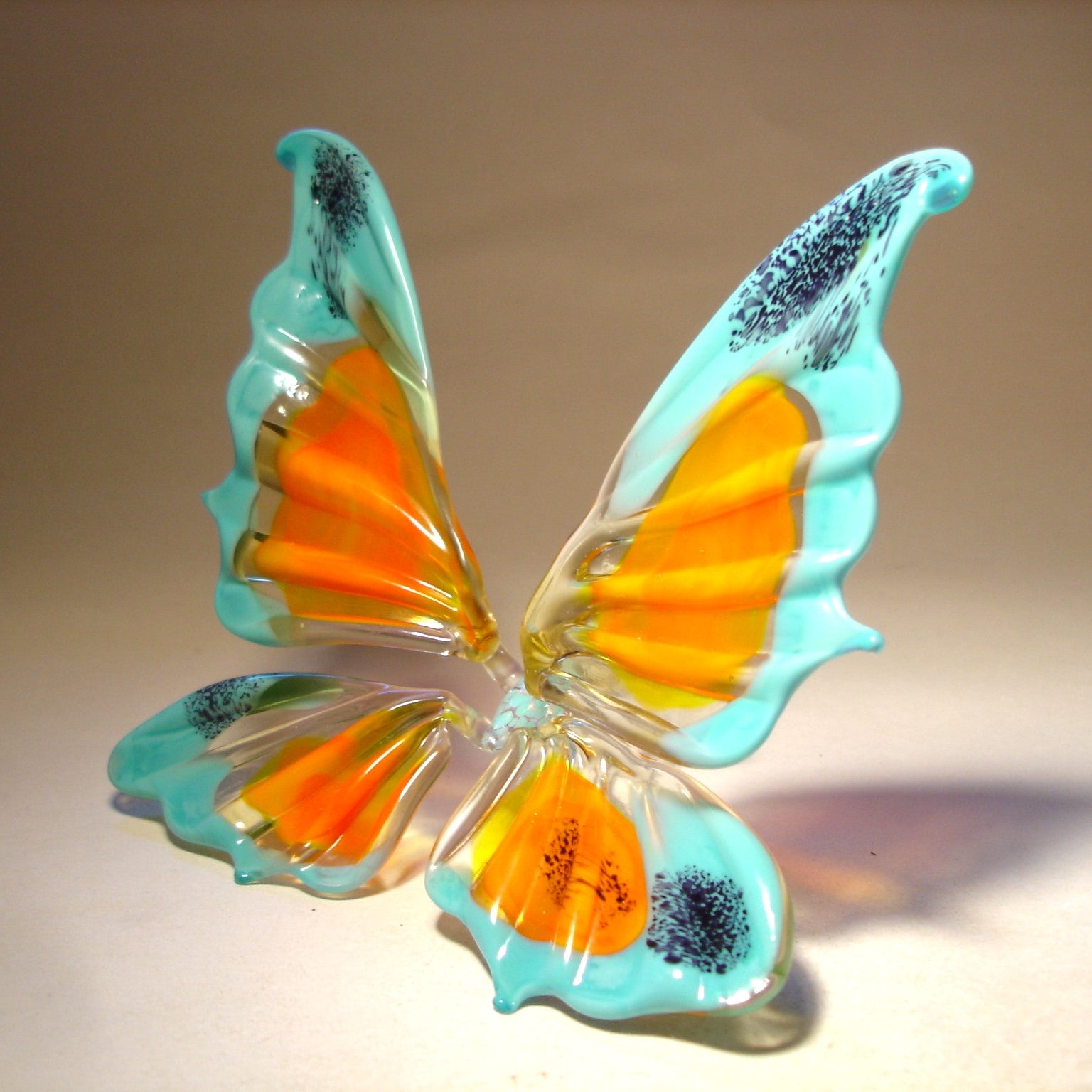 Handmade glass blue and orange figurine - side view