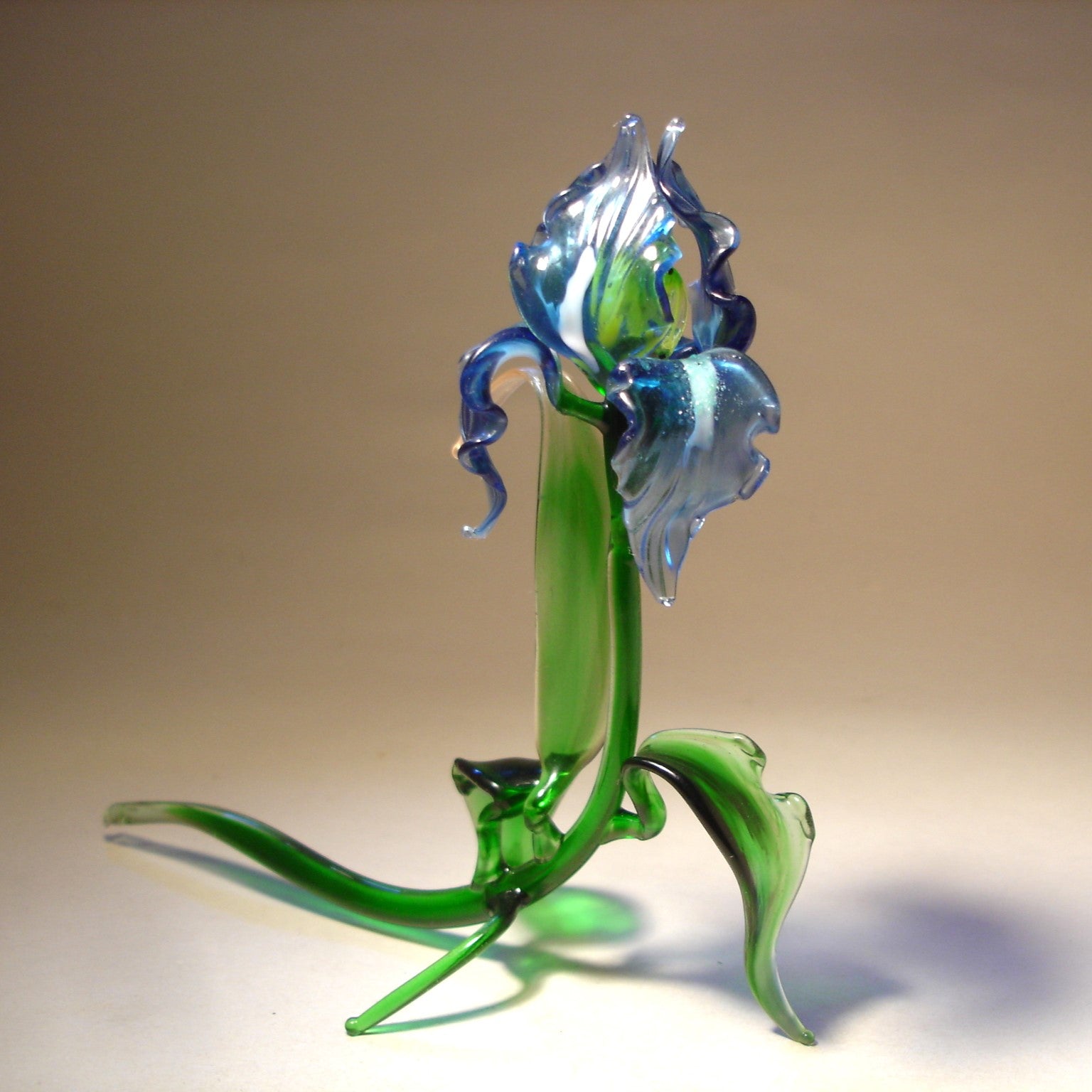 Glass blue iris flower figurine, focusing on the fine craftsmanship of the petals, leaves, and stem.