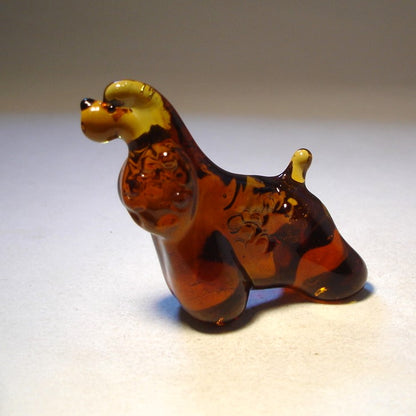 Side view of the glass Cocker Spaniel figurine, displaying its well-proportioned body and fluffy fur.