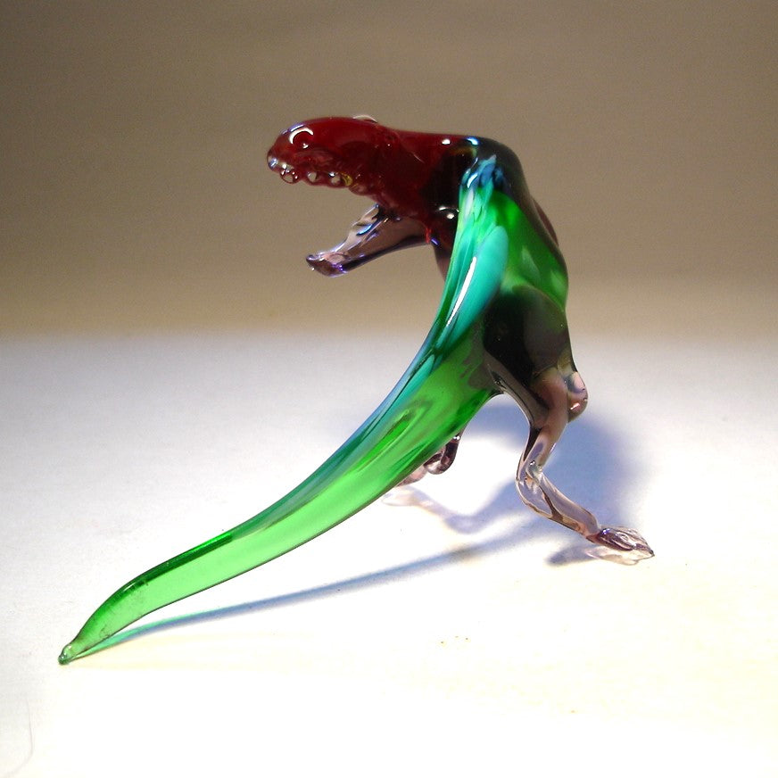 Glass Tyrannosaurus figurine with a turned head with open jaws