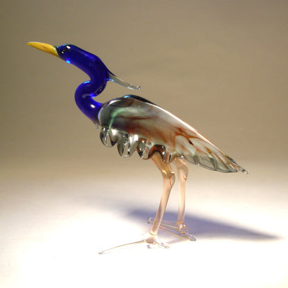 Handmade glass blue neck heron figurine with  intricate details of its feathers and poised posture.