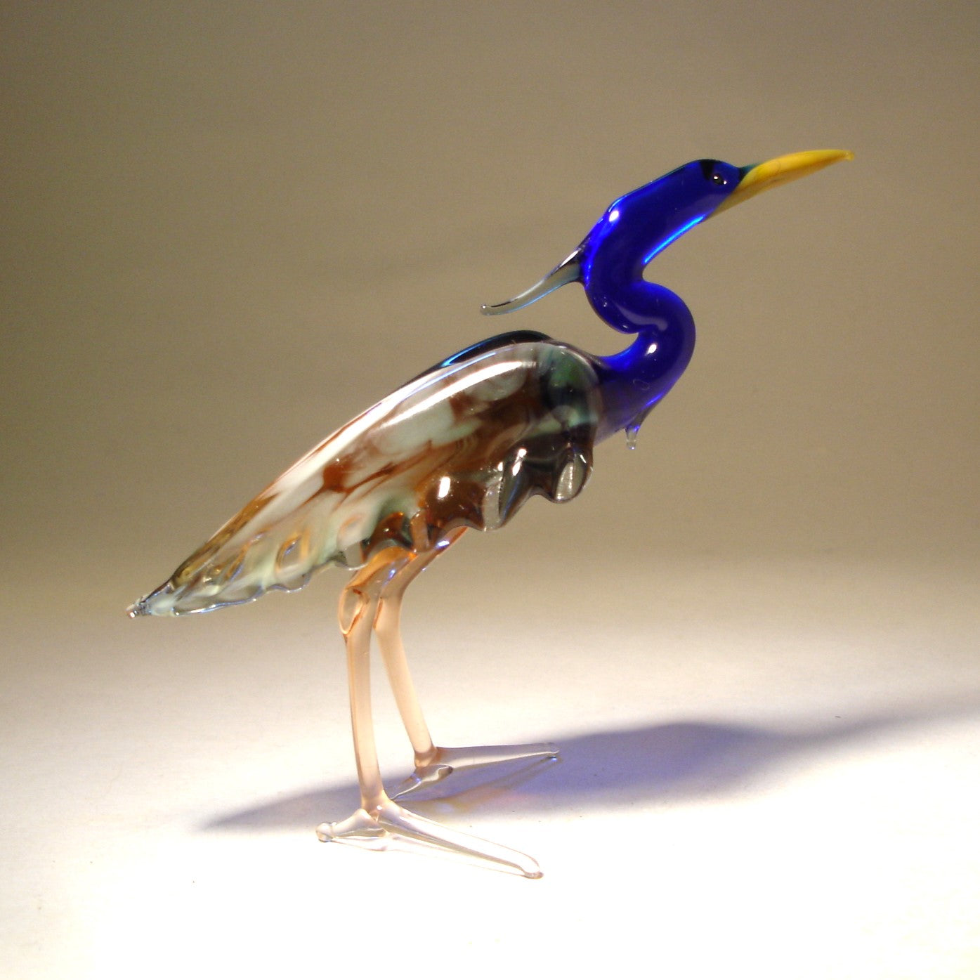 Front view of a glass blue neck heron figurine, showcasing its elegant stance and long, graceful neck.