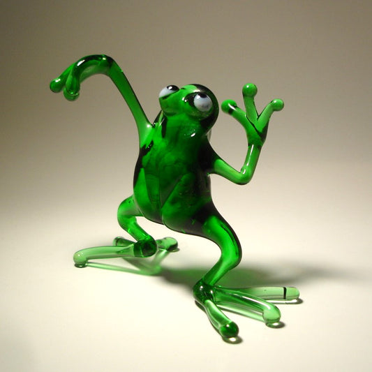 Front view of a glass dancing frog figurine, showing the frog mid-dance with one leg slightly raised and arms extended.