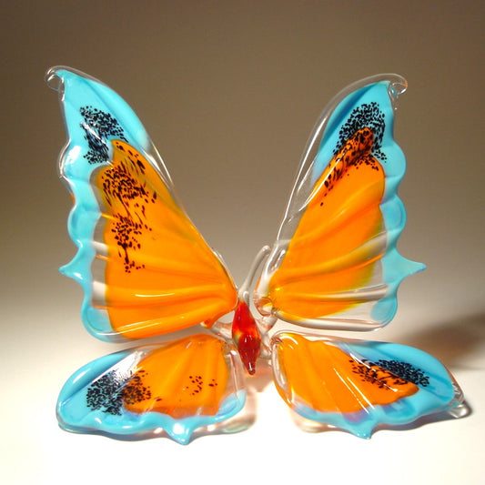 Hand blown glass butterfly figurine in blue and orange colors, perfect as a decorative art piece or meaningful gift