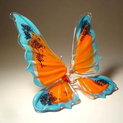 Blue and Orange Glass Butterfly figurine with black specs on it's wings' tips