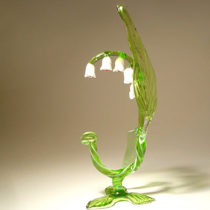 A side view of the glass Lily of the Valley flower figurine, capturing its graceful curves and the arrangement of flowers along the stem.