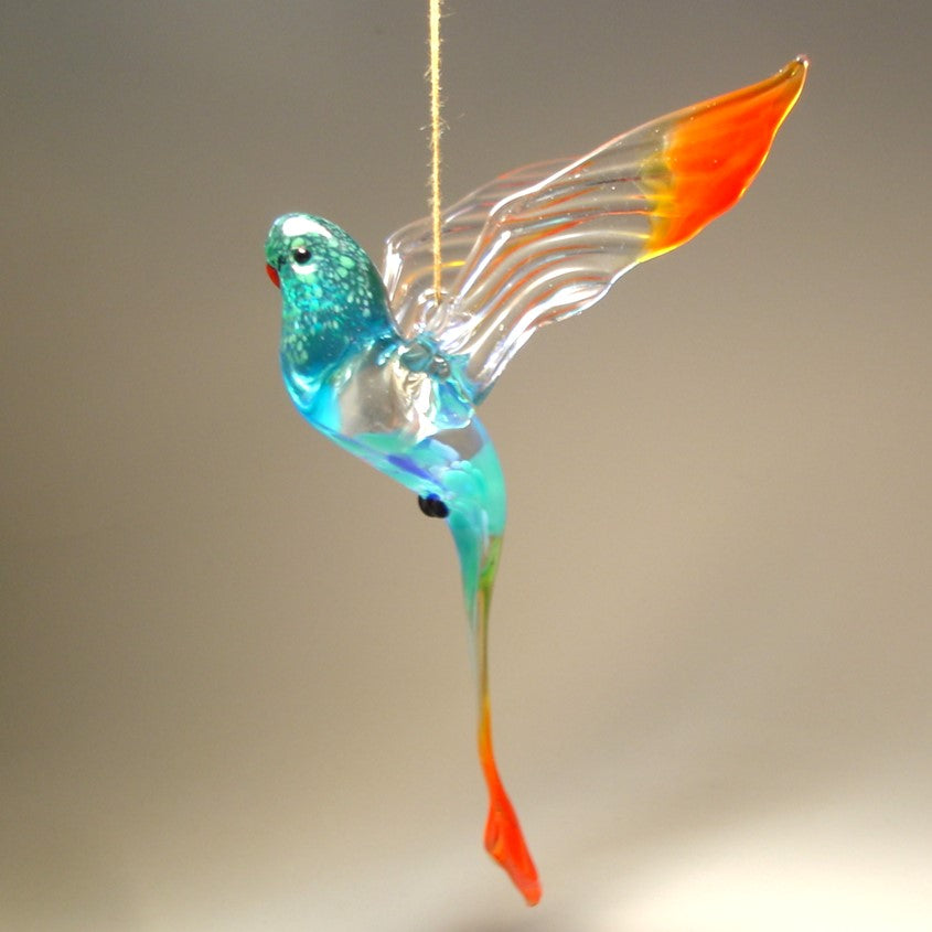 A colorful glass Hanging Blue & Red Parrot Parakeet ornament, gracefully suspended, showcasing its vibrant blue and red feathers.