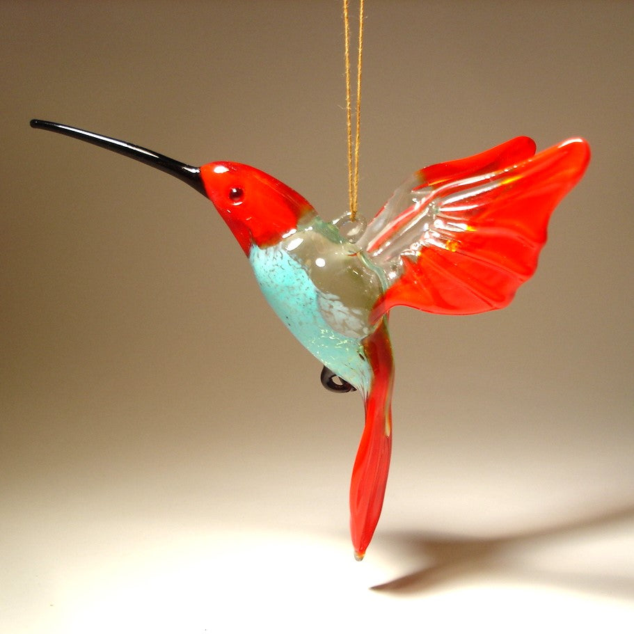 Glass hummingbird ornament with red wings and blue belly
