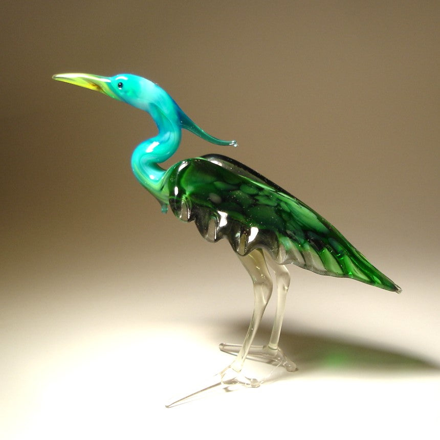 Handmade glass blue neck heron figurine with  intricate details of its feathers and poised posture.