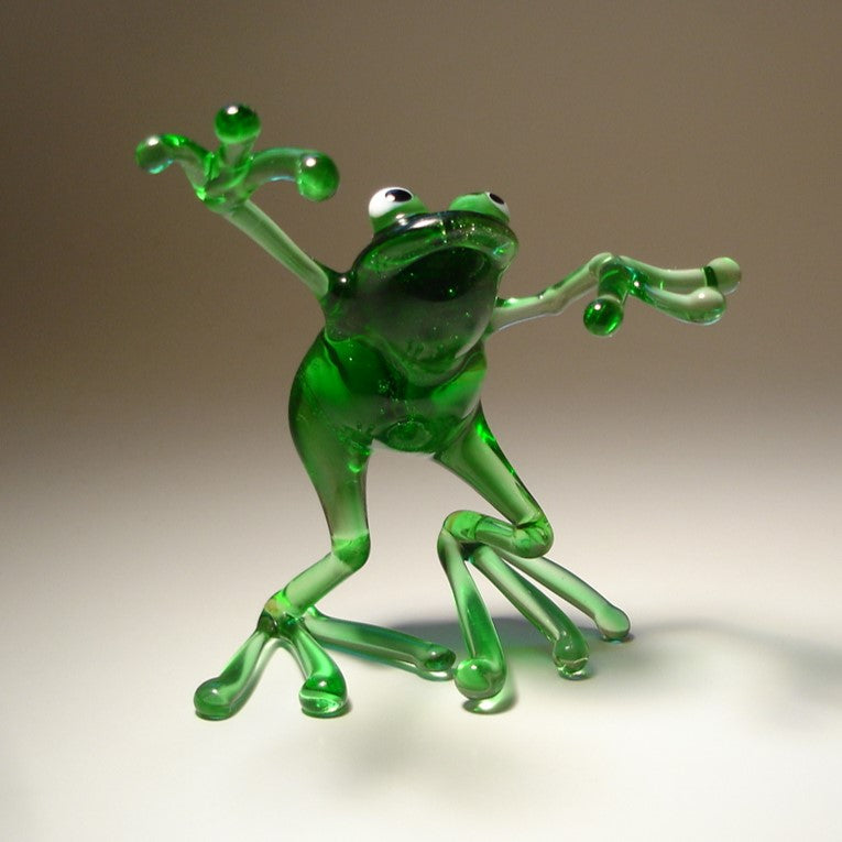 Front view of the glass dancing frog figurine, emphasizing the happy lively posture.