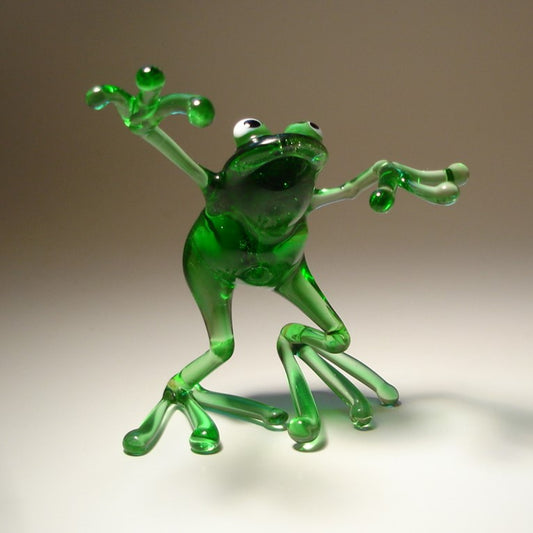 Front view of the glass dancing frog figurine, emphasizing the happy lively posture.
