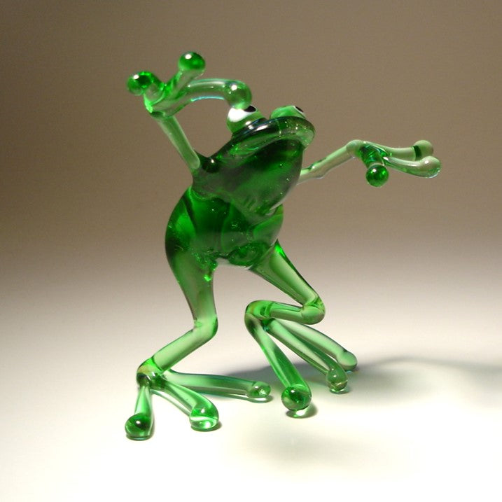 Close-up of the glass dancing frog figurine, capturing the cheerful expression and animated dance movement.