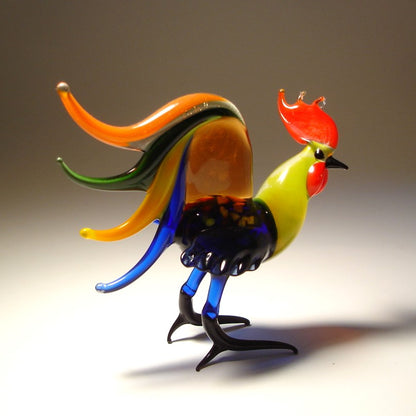 Colorful glass rooster sculpture on a gradient background