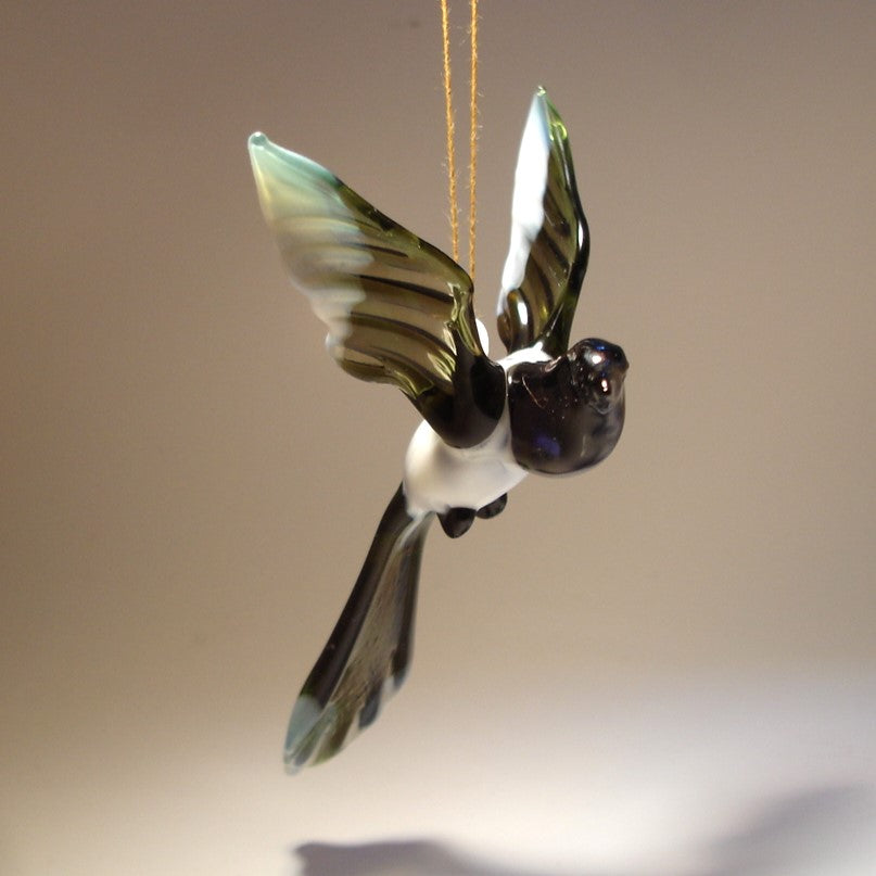 The glass Hanging Bird Magpie figurine ornament displayed from a different angle, highlighting its sleek body and the elegant curve of its tail feathers.