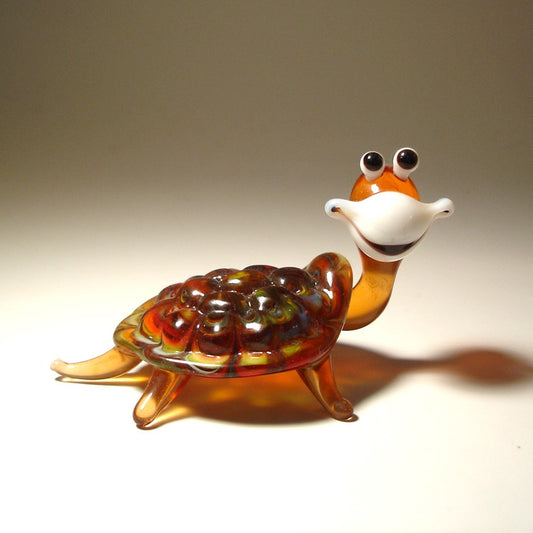 Brown glass turtle with white smiling face 
