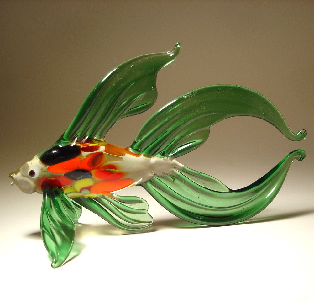 A green glass Betta fish figurine, showcasing its wide, flowing fins and slightly flared tail.