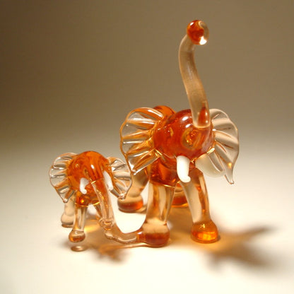 Front view of the glass elephants with a mother on the right.