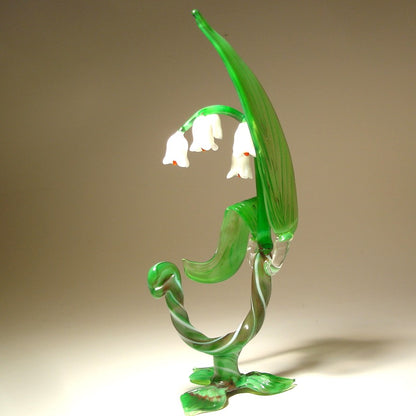 A side view of the glass Lily of the Valley flower figurine, capturing its graceful curves and the arrangement of flowers along the stem.