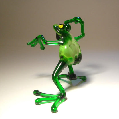 Close-up of the glass dancing frog figurine, capturing the cheerful expression and animated dance movement.