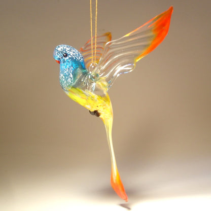 A colorful glass handmade Blue, Yellow & Red Parrot Parakeet ornament.