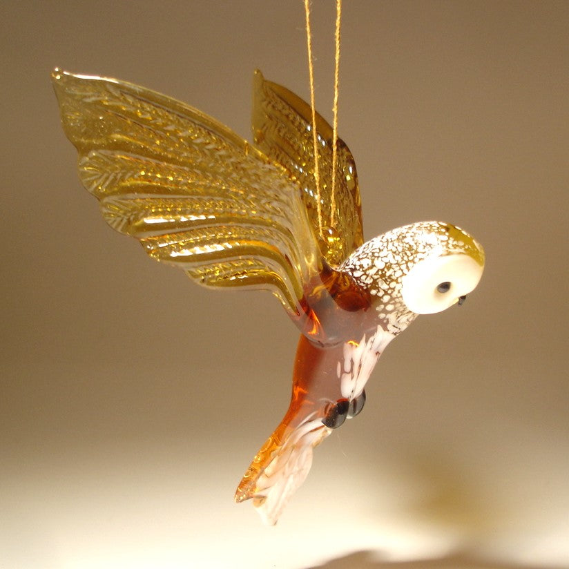 Handmade glass brown owl figurine ornament suspended from a string