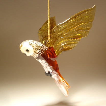 Close-up view of the glass brown owl figurine ornament, focusing on the intricate detailing of the beak, white face.