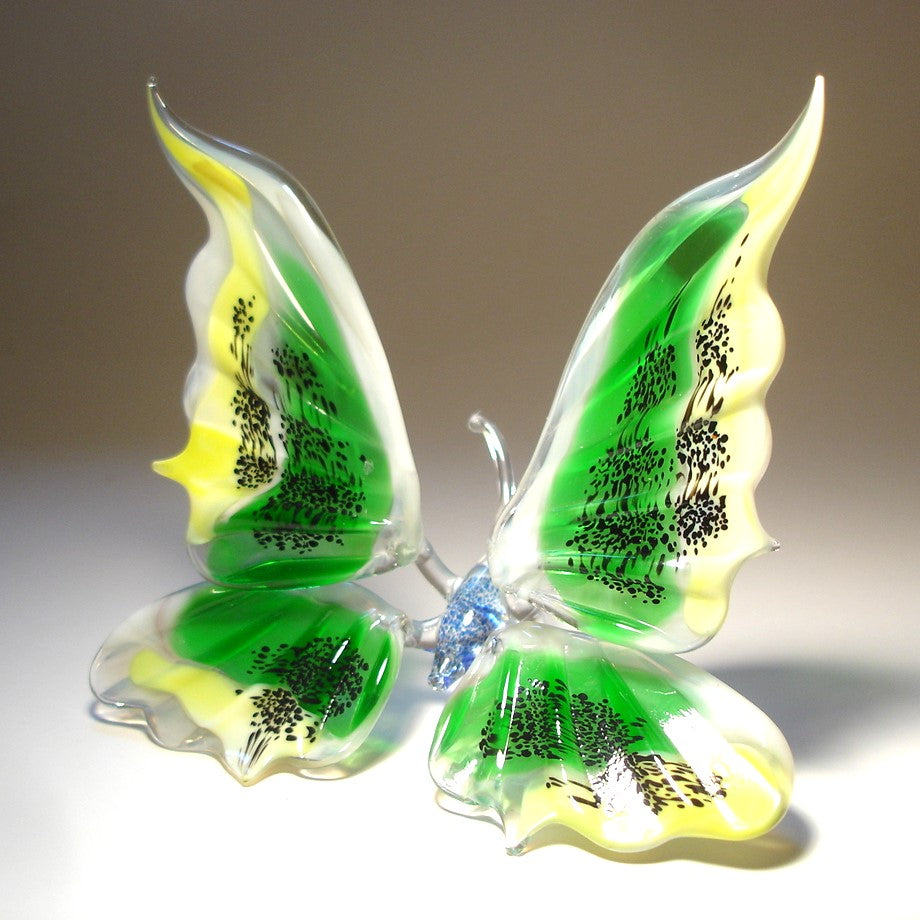 Glass butterfly figurine wiyj black dots all over green and yellow wings