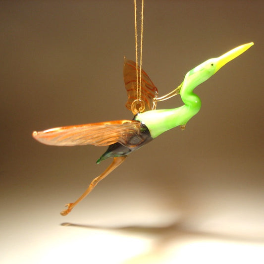 Side view of the Glass Heron in Flight Hanging Figurine, highlighting the bird's graceful posture and elongated neck mid-flight.