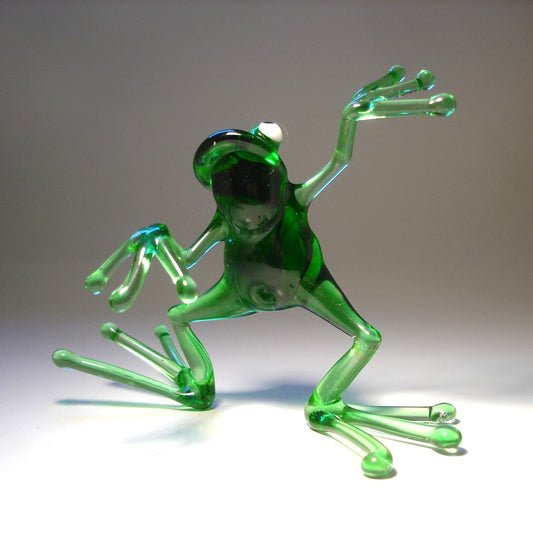 Front view of the glass dancing frog figurine, emphasizing the happy lively posture.