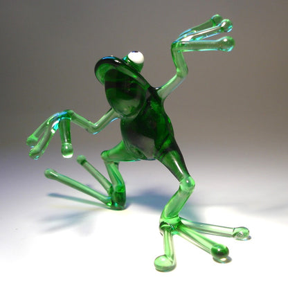 Close-up of the glass dancing frog figurine, capturing the cheerful expression and animated dance movement.