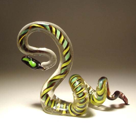Handmade glass snake with a serpentine like green-black and yellow pattern.