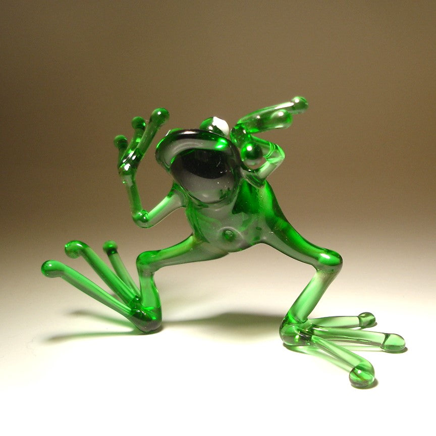 Close-up of the glass dancing frog figurine, focusing on the frog's joyful expression and dynamic dance pose.
