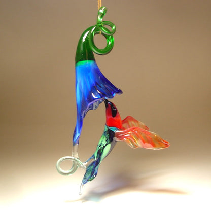 The other view of the blue trumpet flower and green and red hummingbird with a blue head